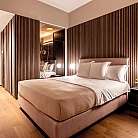 Camera da letto con pareti in legno e illuminazione elegante.